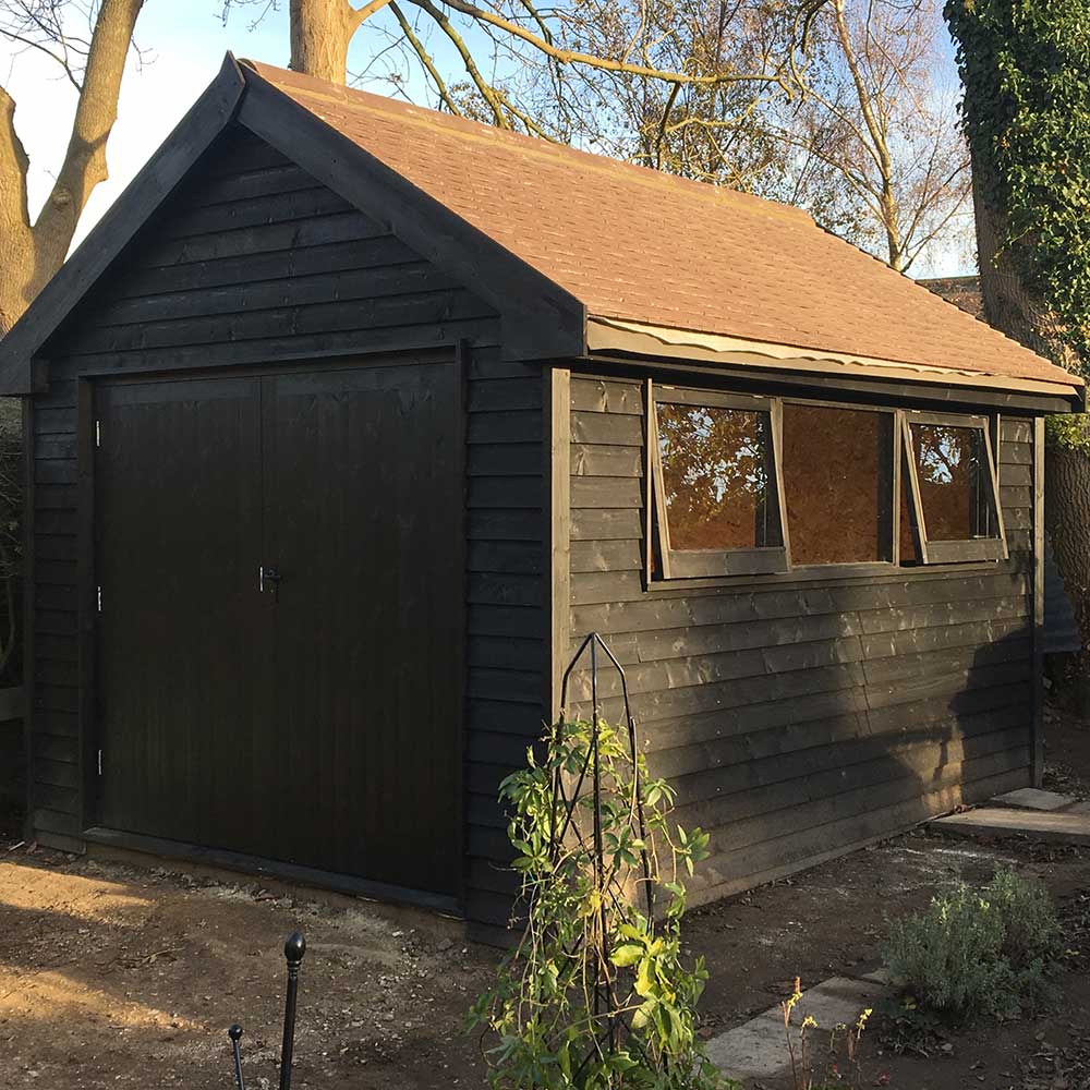 Garden workshop building with double doors and windows